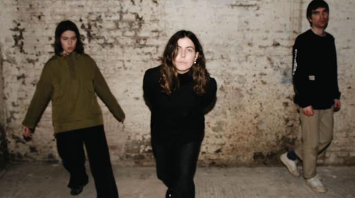 Trio Voka Gentle stood in front of a brick wall